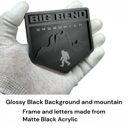 Matte and gloss black acrylic mountain badge detail with layered 3D design Sasquatch engraved