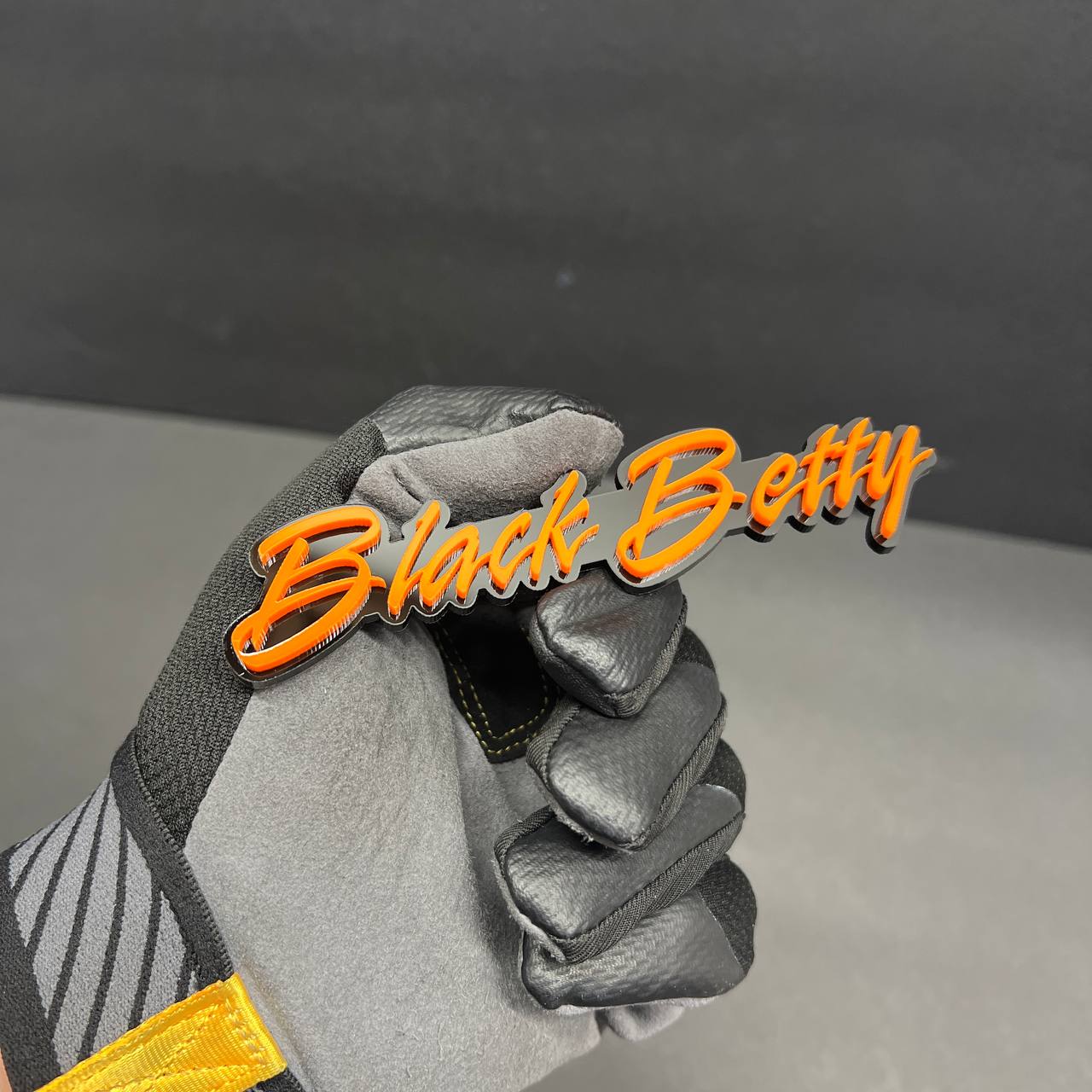 Performance style Black Betty custom text badge with layered acrylic design