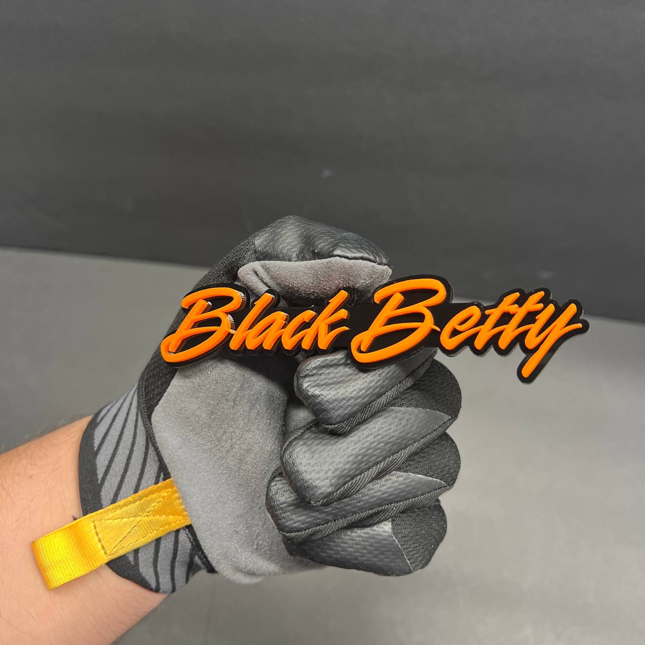 Black Betty acrylic car emblem with bold script lettering and glossy finish