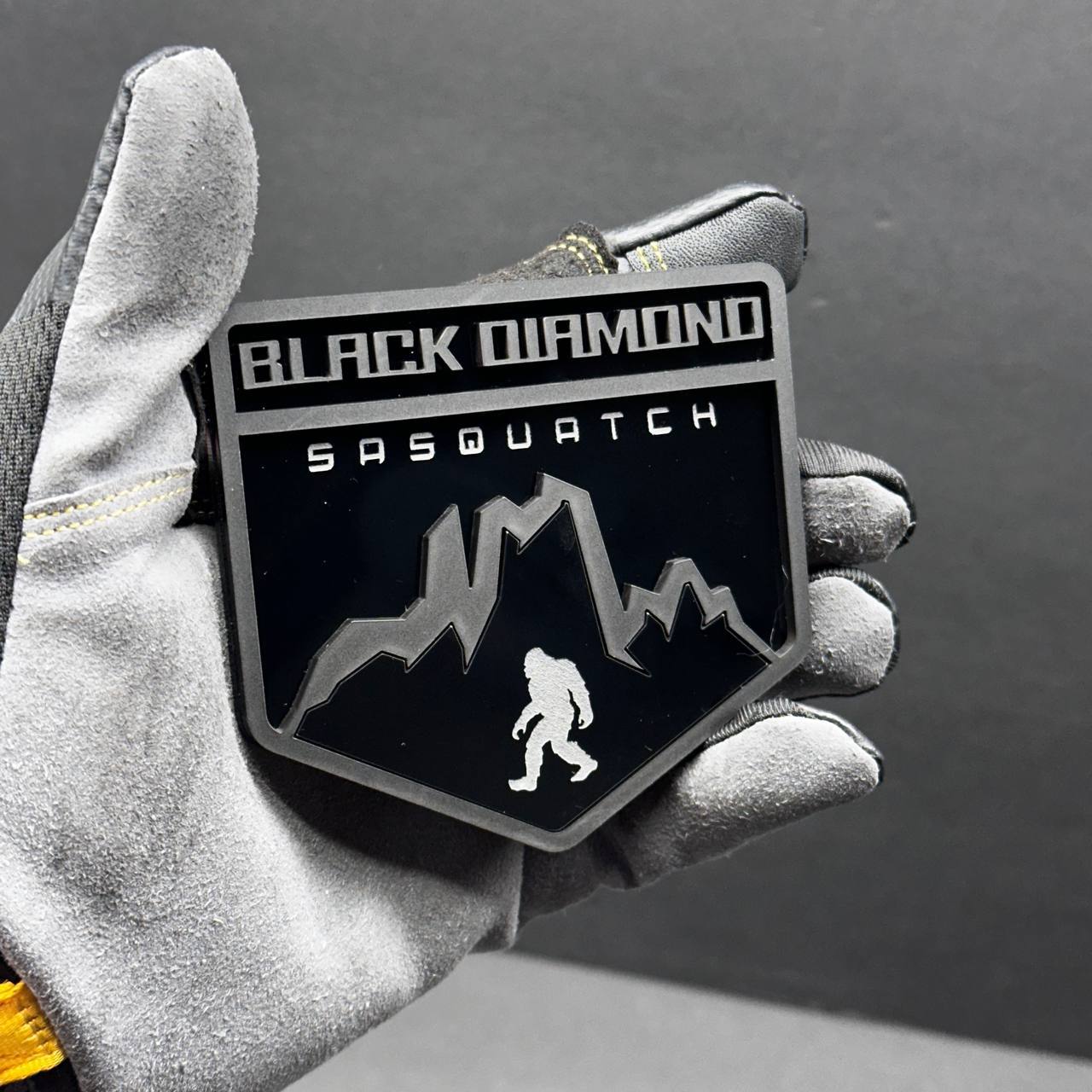 Black and gray Black Diamond Sasquatch exterior badge for truck or SUV fender