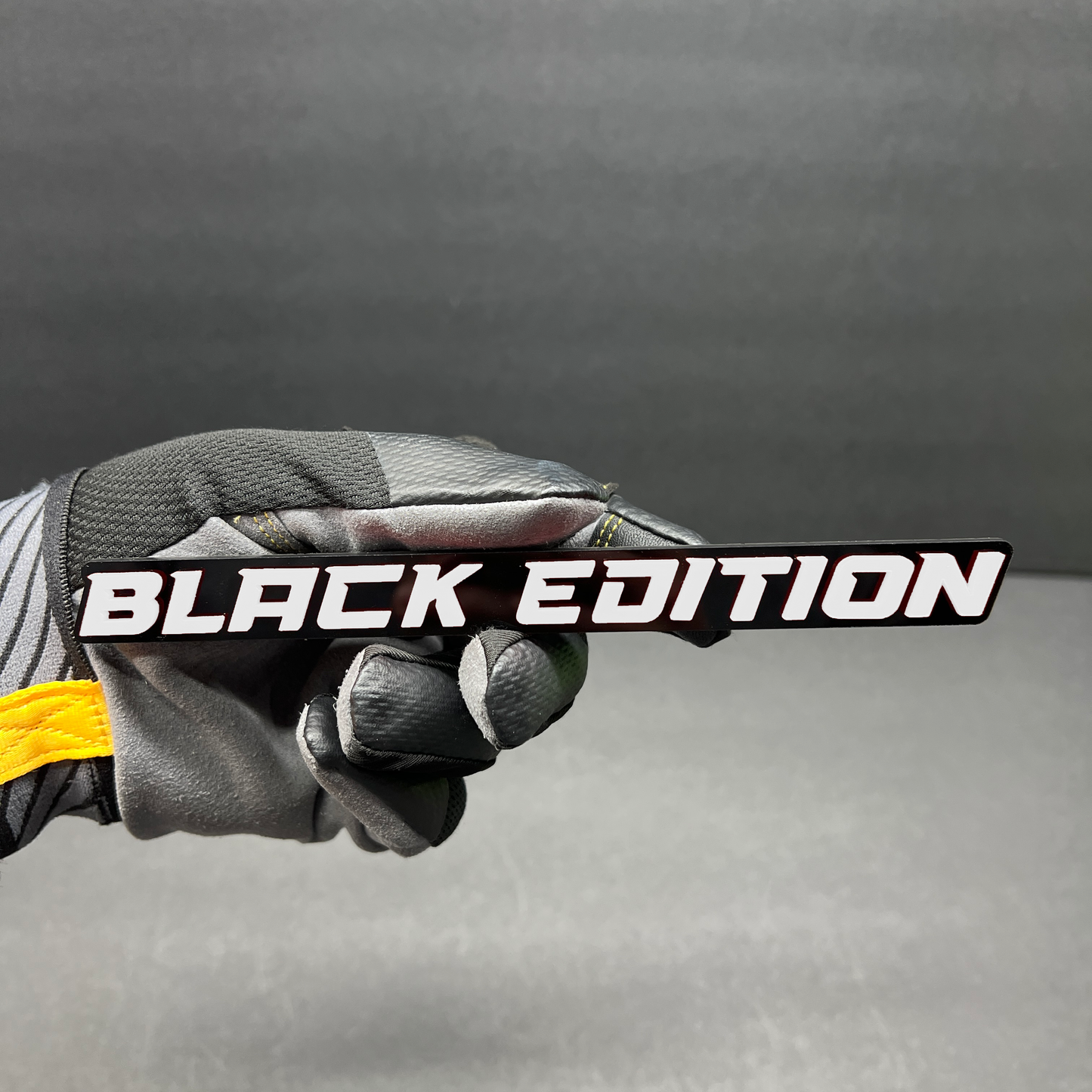 White and black Black Edition custom vehicle badge for automotive customization