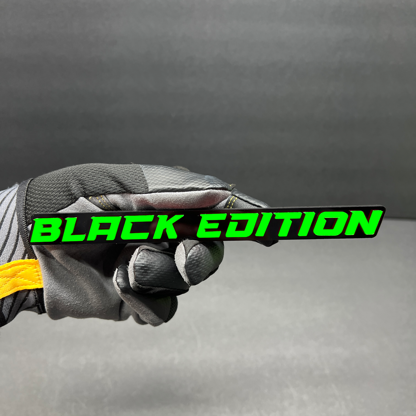 Black Edition custom car badge with white lettering on a gloss black background.