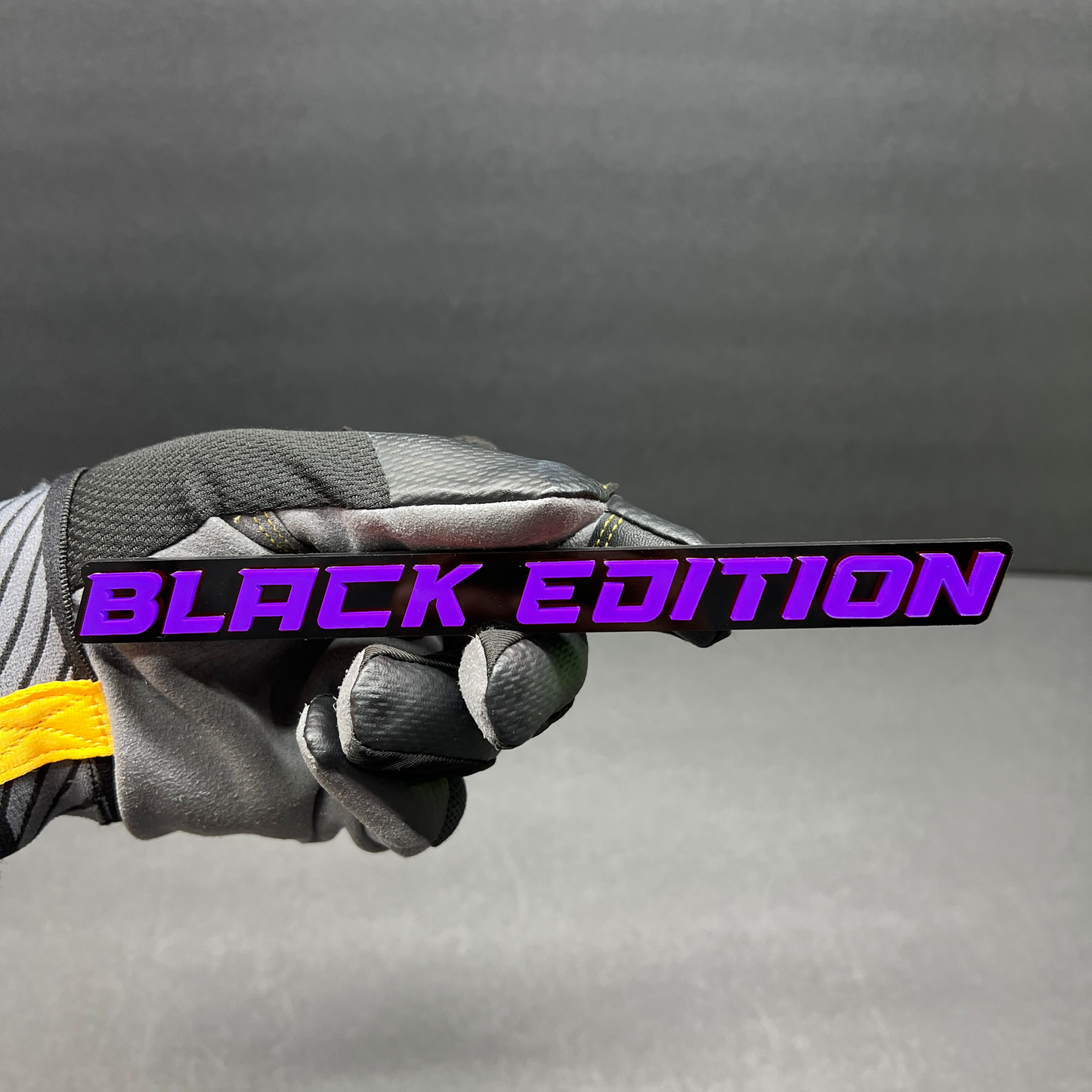 Gloss black Black Edition text emblem with bold white raised lettering.
