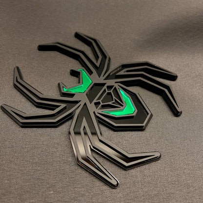 Black and green spider trailer hitch receiver cover with modern geometric automotive styling.