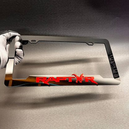 Glossy black car license plate frame featuring red Raptor lettering