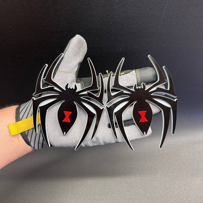Two matching Black Widow spider fender emblems with black legs and red center accents
