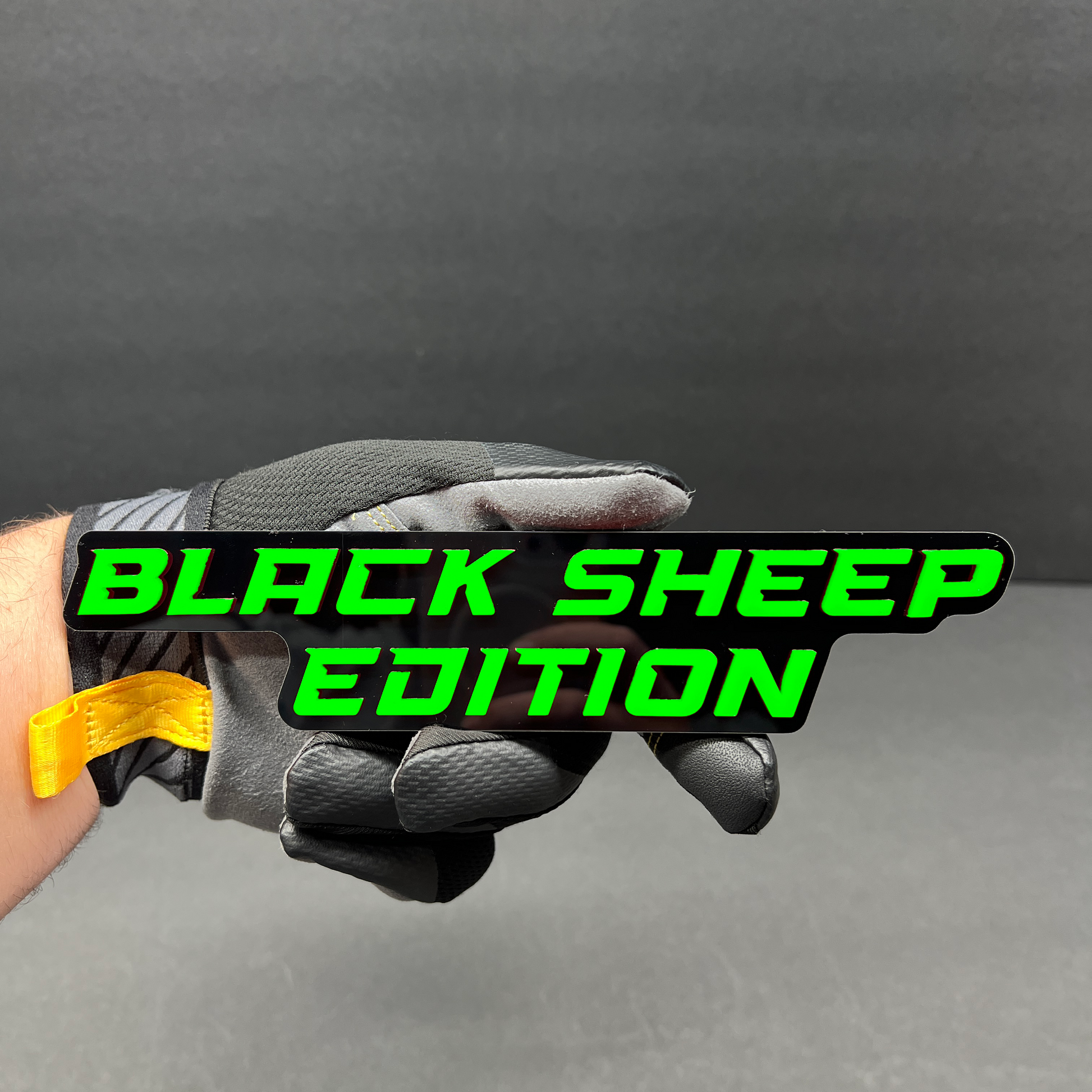 Black Sheep Edition custom car badge in red and black with glossy finish.
