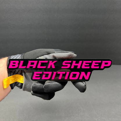 Glossy black Black Sheep Edition badge with raised red lettering.