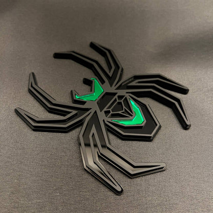 Black Widow spider receiver hitch cover with matte black finish and vivid green detailing.