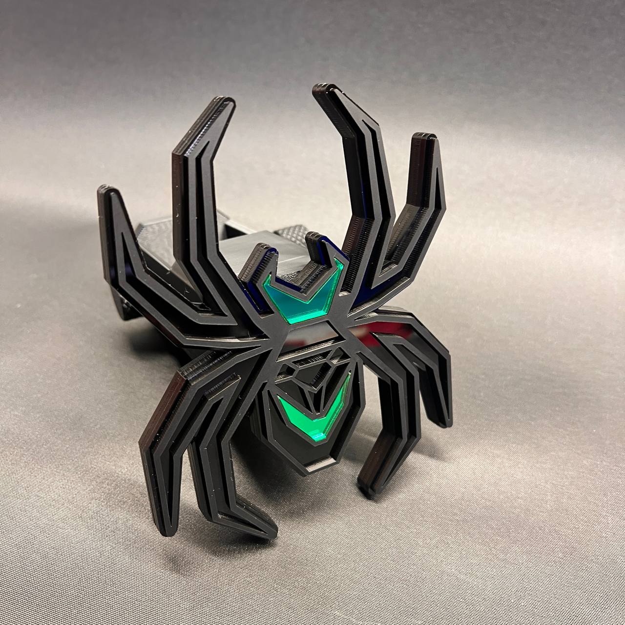 Matte black and poison green Black Widow hitch receiver cover with layered spider design.