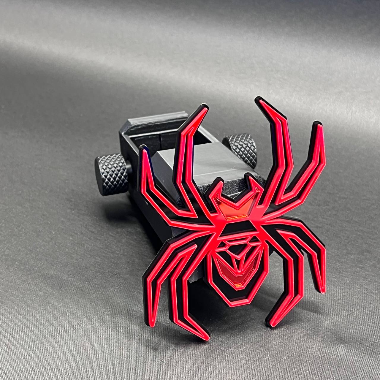 Heavy-duty Black Widow receiver hitch cover with bold mirror red spider emblem.