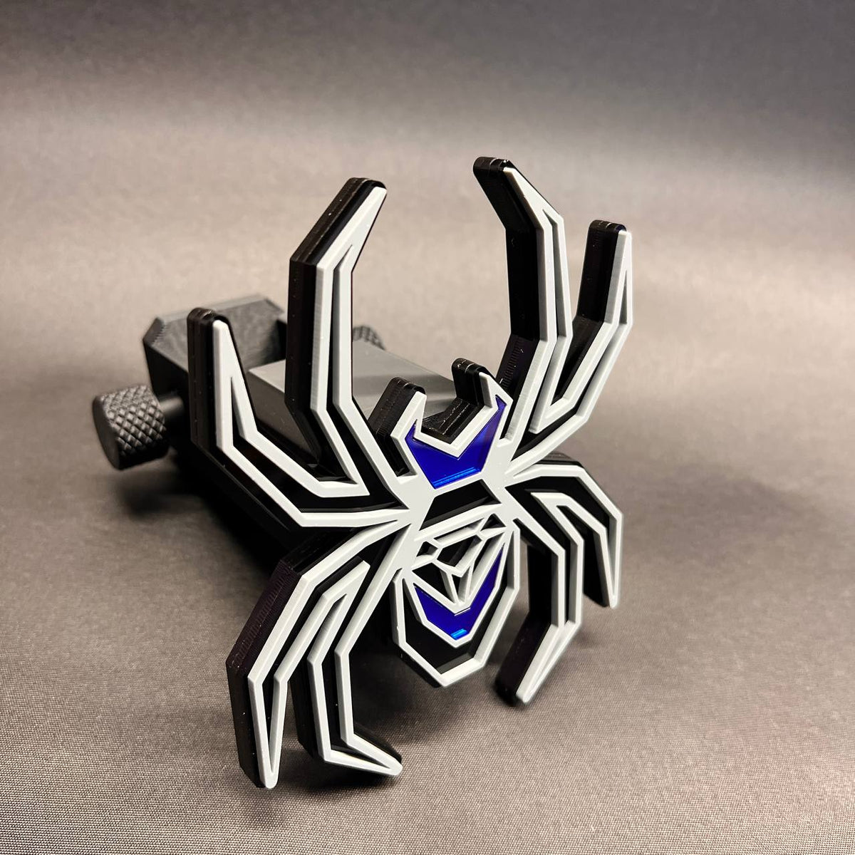 Custom gray and black spider hitch cover with mirror blue highlights and layered construction.