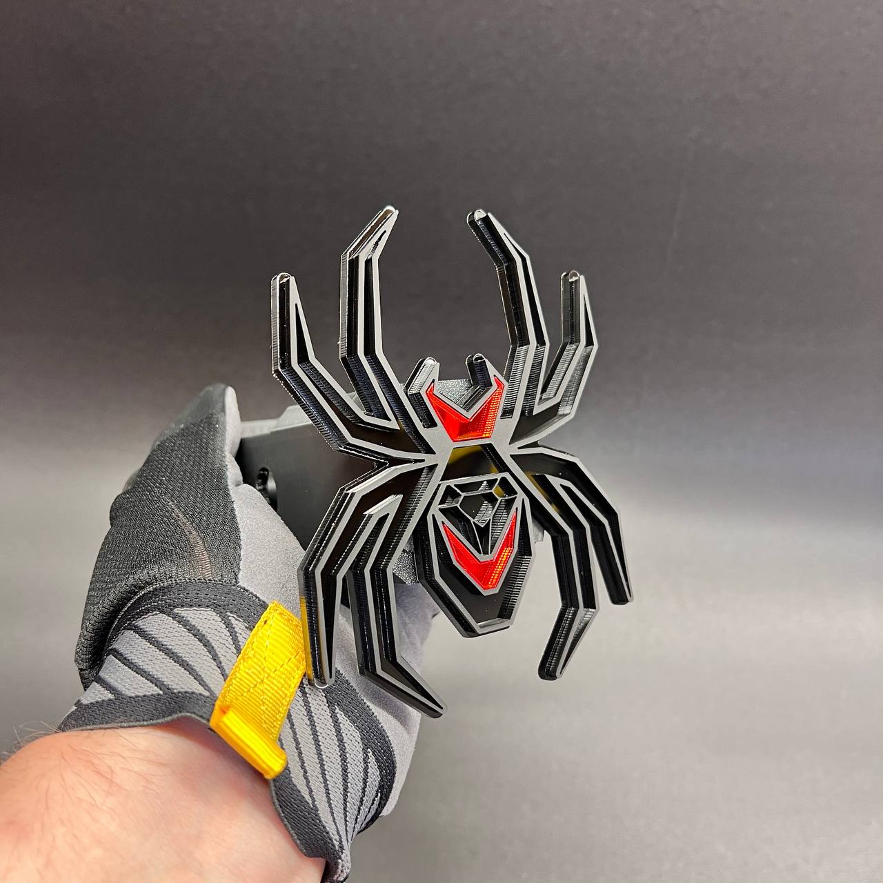Aggressive spider hitch cover badge with red accent and black layered design