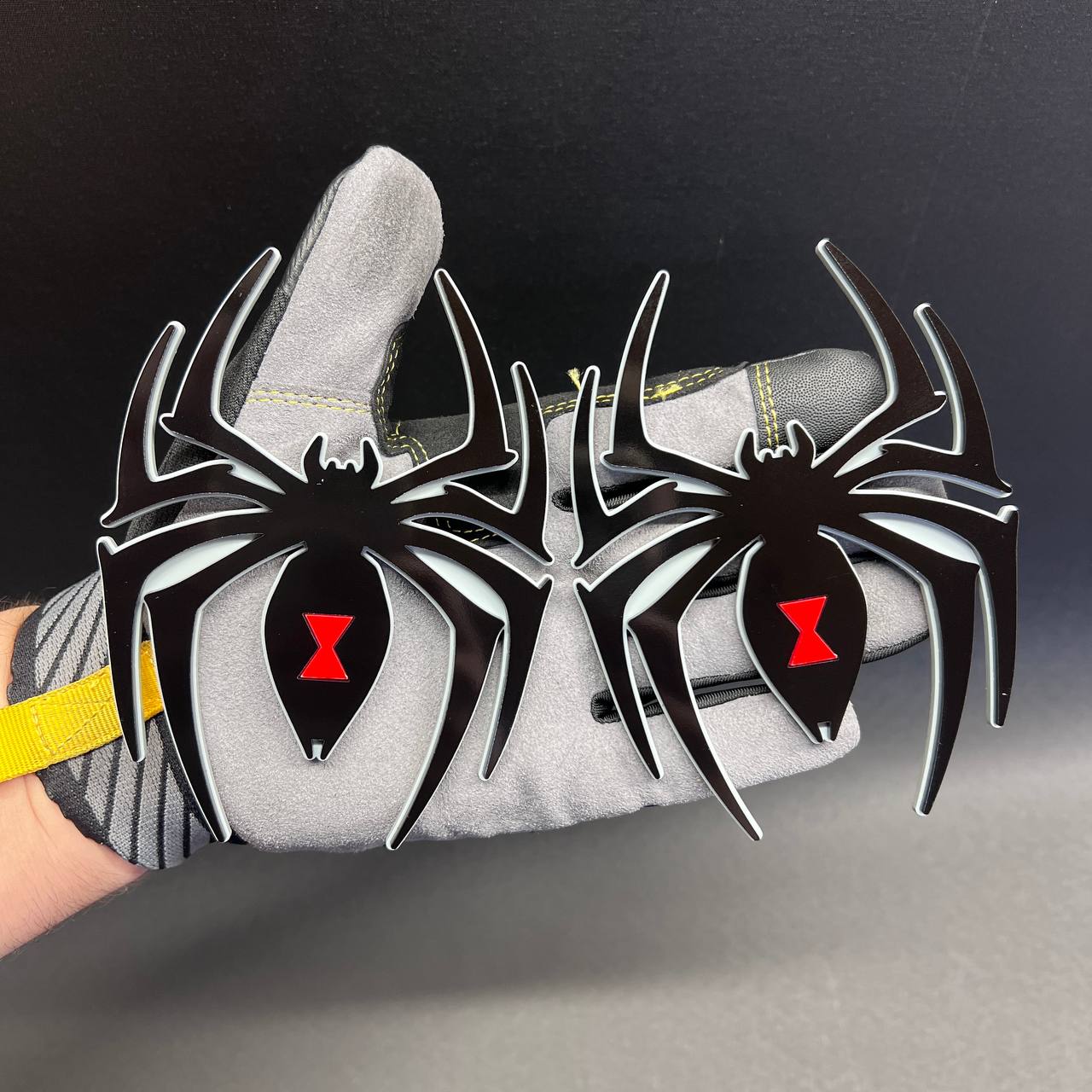 Custom Black Widow spider car badge featuring a red hourglass symbol and glossy black finish