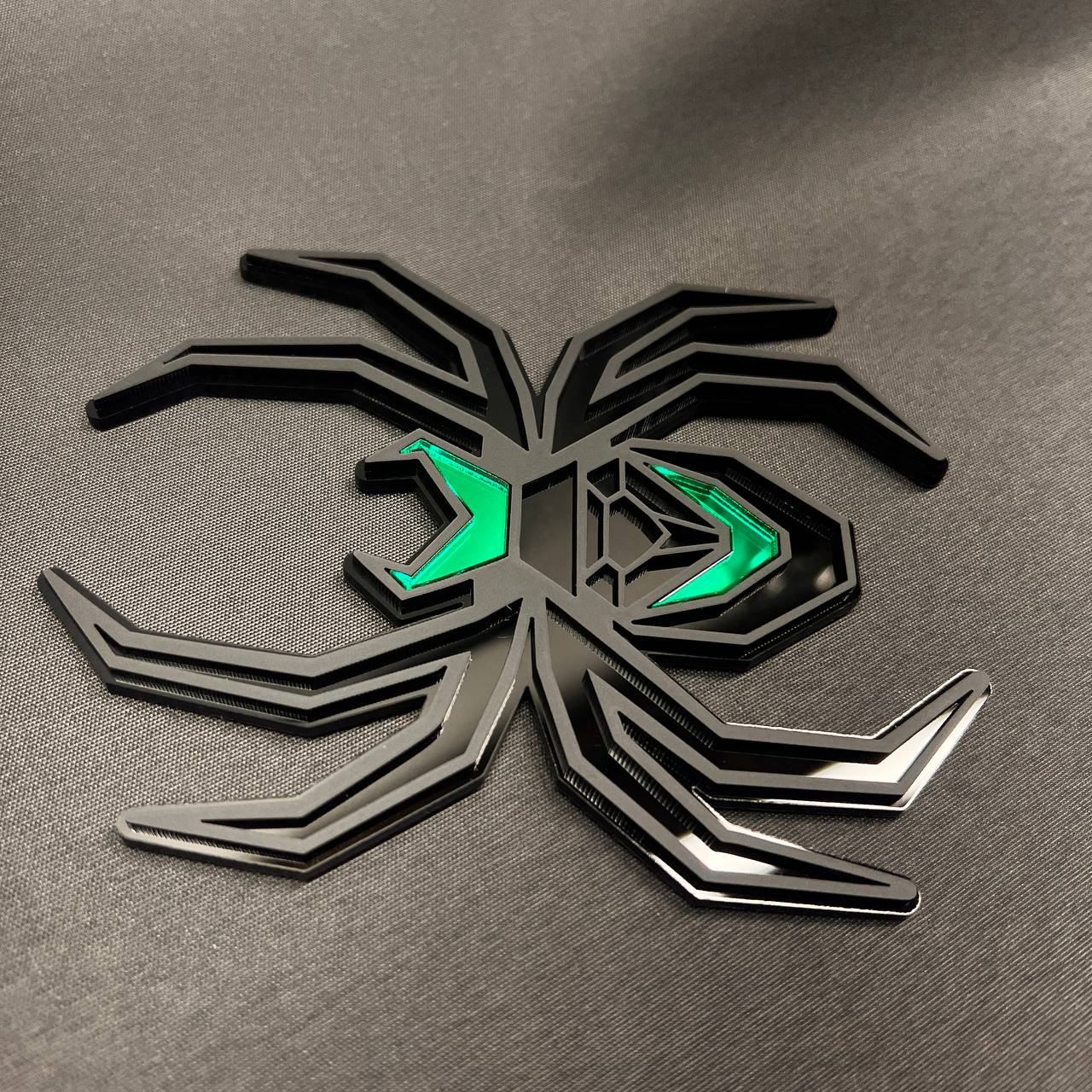 Custom Black Widow car badge style hitch cover featuring black layered legs and green accents.