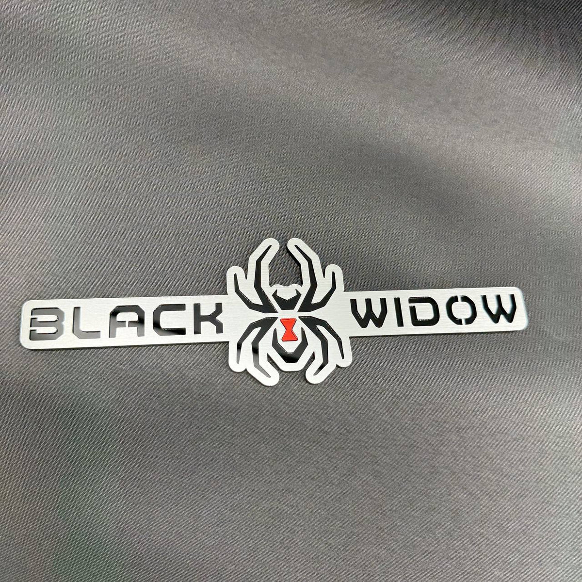 Black Widow spider fender badge accessory for Ford F150 and other compatible pickup truck applications.