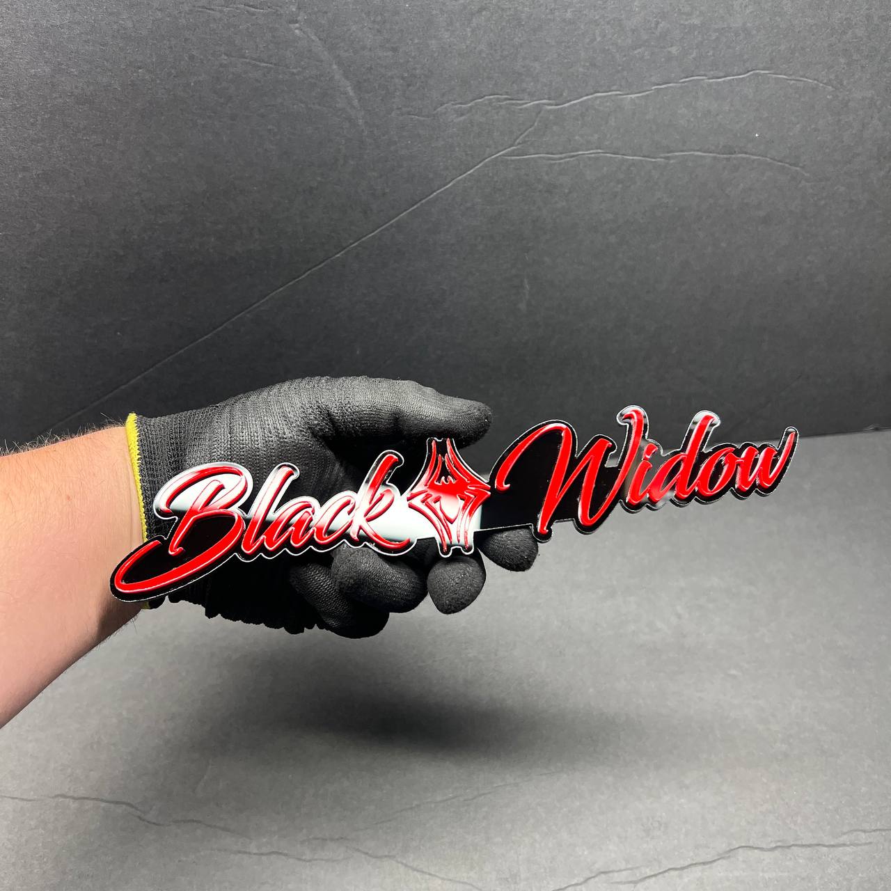 Close-up of Black Widow 3D acrylic racing emblem showing sharp drip lettering details