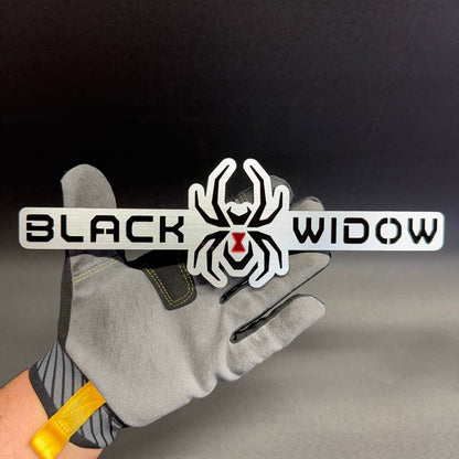 Black Widow spider tailgate emblem accessory for Toyota Tacoma and Tundra pickup truck customization.