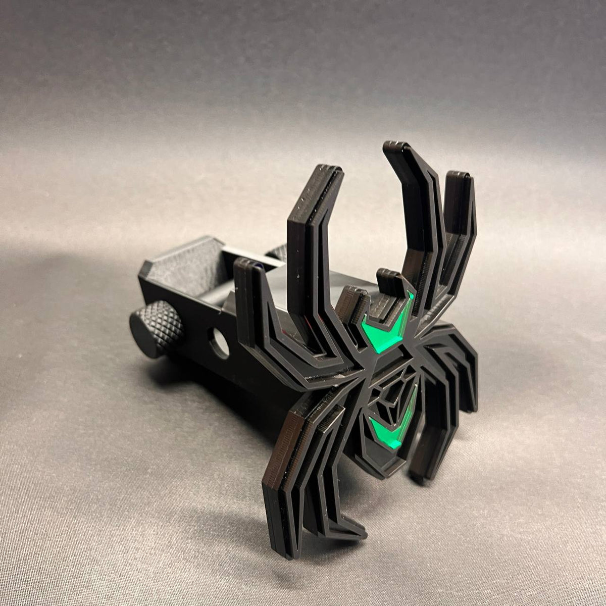 Black Widow car badge style hitch cover featuring matte black and bright green color contrast