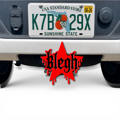 Red and black BLEGH 3D hitch cover mounted below a truck license plate as a custom exterior accessory