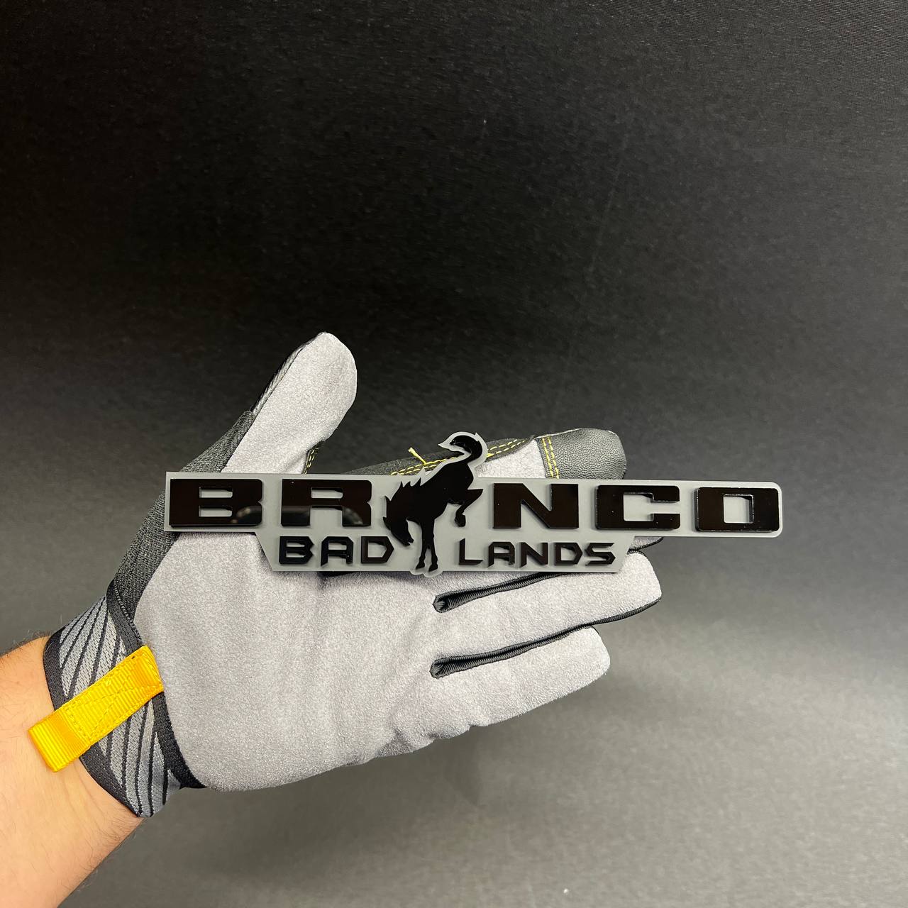 Raised letter BRONCO BADLANDS vehicle emblem in black and gray finish