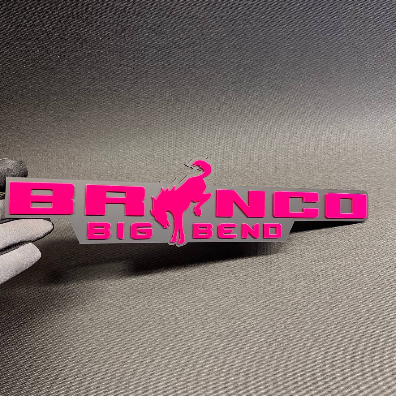 Pink and gray Bronco Big Bend car emblem with bucking horse design