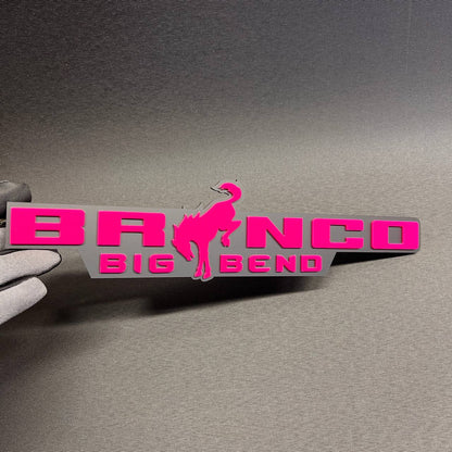 Pink and gray Bronco Big Bend car emblem with bucking horse design