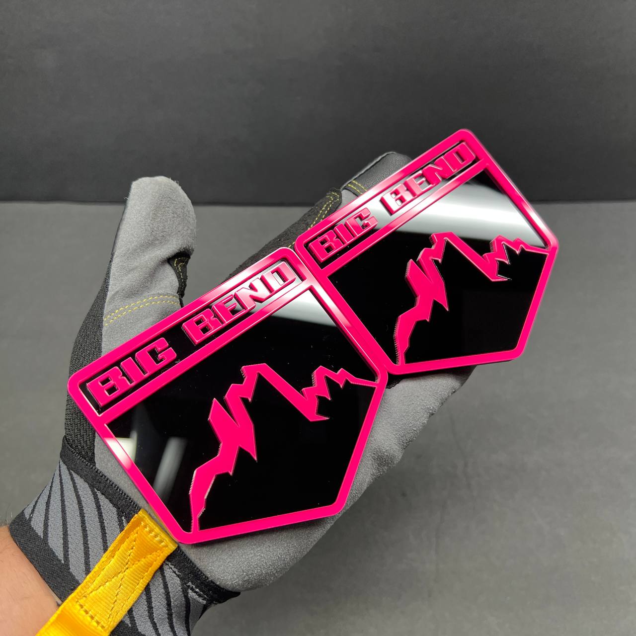 Pink and gloss black acrylic mountain badge detail with layered 3D design