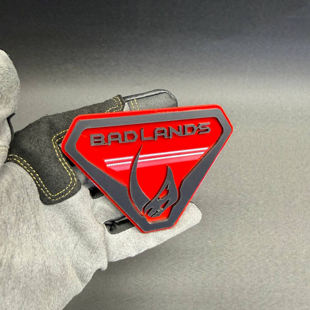 Decorative Bronco Mudhorn skull logo badge featuring precision-cut layered construction, bold red finish and black automotive emblem accents.