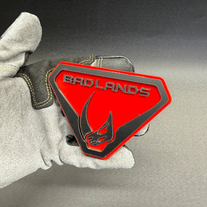 Mudhorn Badlands inspired car badge with raised black details and red shield background for Bronco, Jeep Wrangler and Gladiator custom builds.