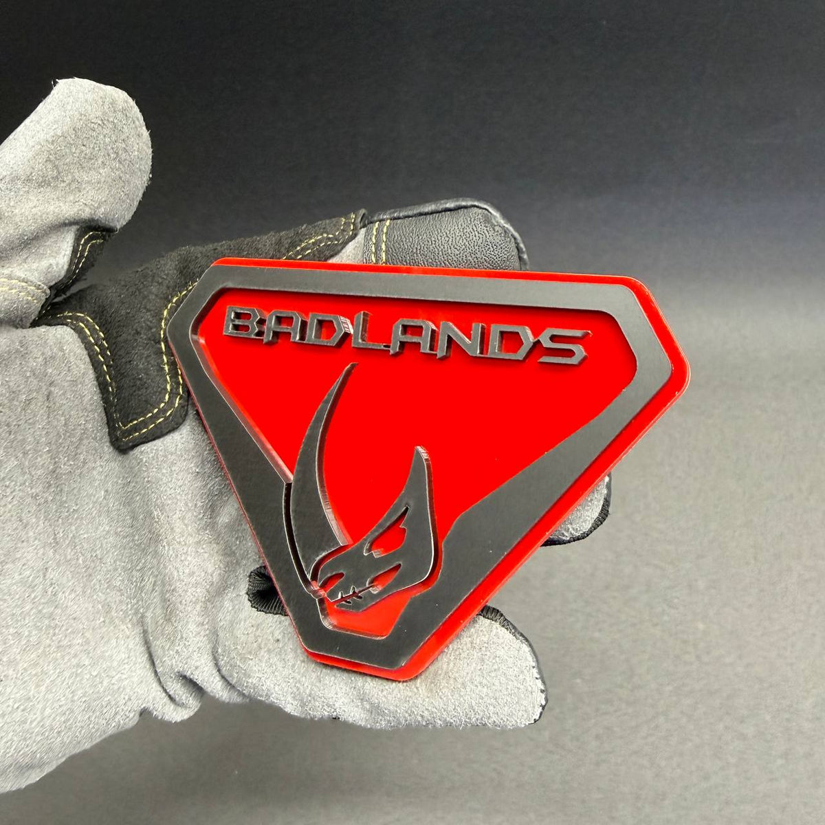 Red and black Mudhorn Badlands grille emblem designed for Ford Bronco Badlands, Bronco Wildtrak, Big Bend and Outer Banks customization.
