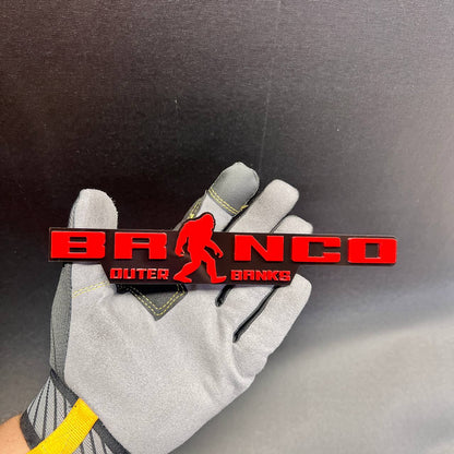 Red Bronco Outer Banks car emblem with Sasquatch silhouette and black background