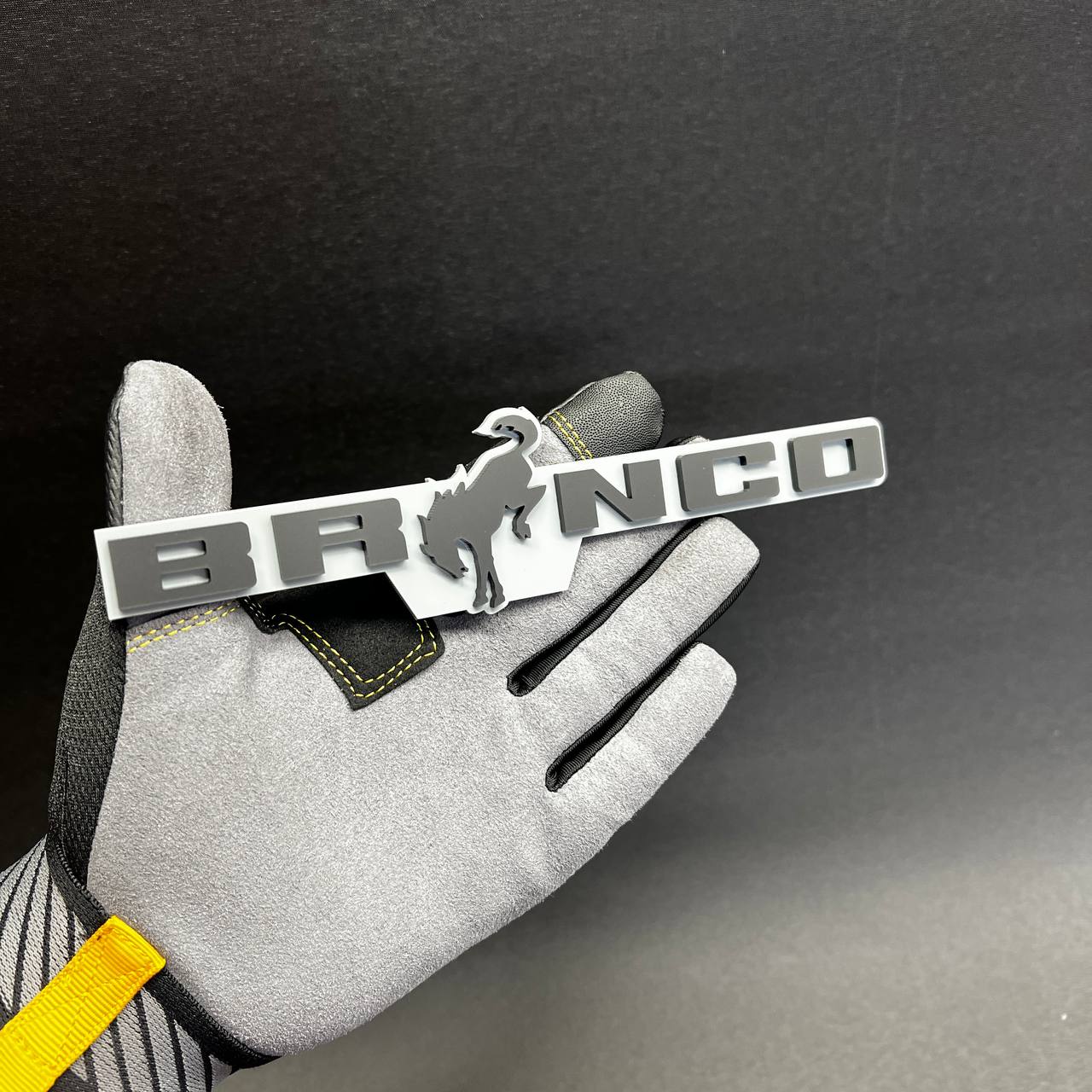Gray and white Bronco car badge fender emblem with horse design