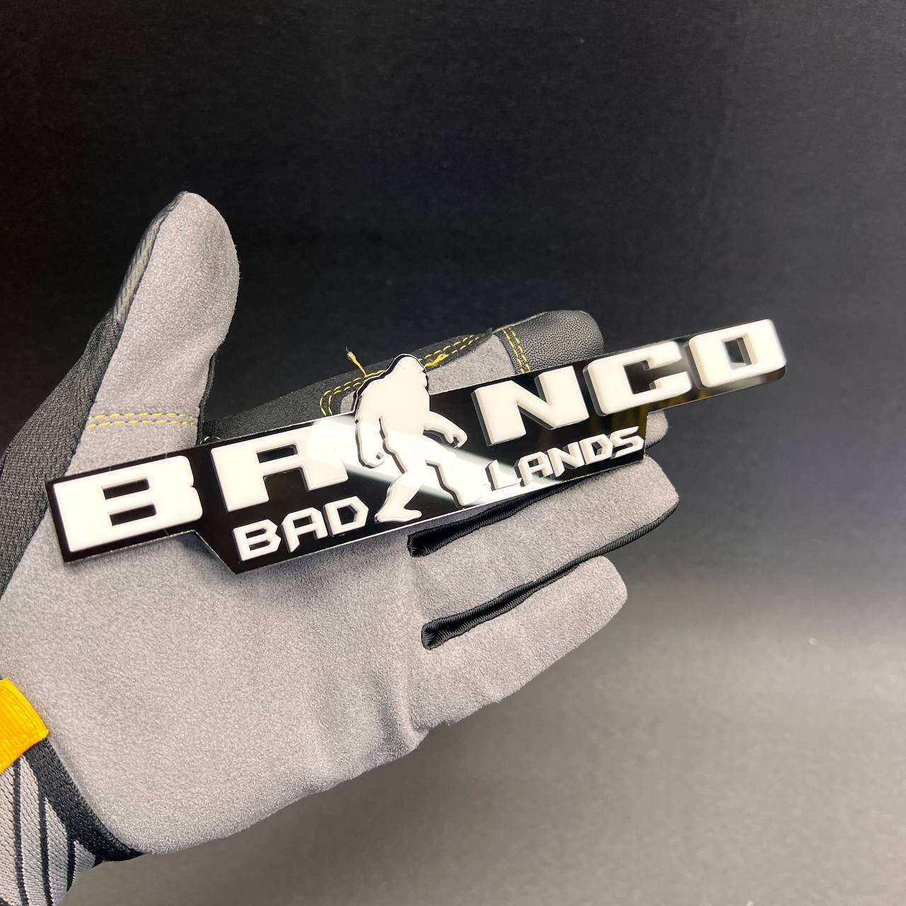 Bronco Sasquatch custom emblem with raised white lettering on black base