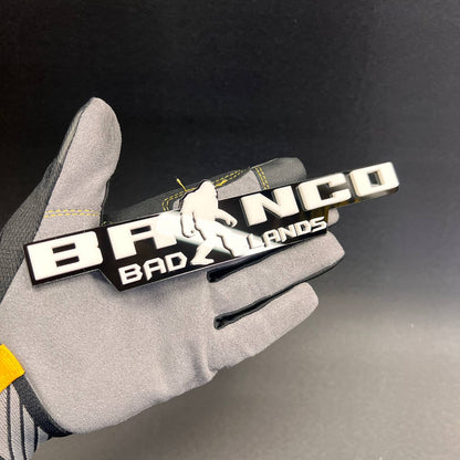 Bronco Sasquatch custom emblem with raised white lettering on black base