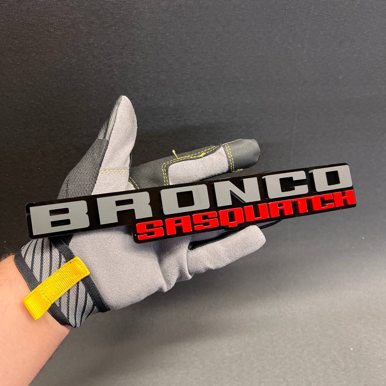 BRONCO SASQUATCH off-road vehicle badge with silver top text and red bottom text
