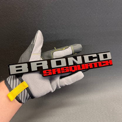 BRONCO SASQUATCH off-road vehicle badge with silver top text and red bottom text