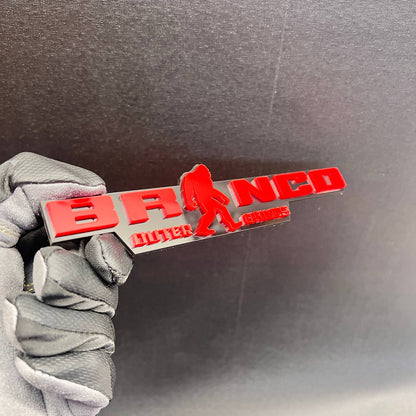 Bronco Sasquatch Outer Banks fender badge featuring a walking Bigfoot design