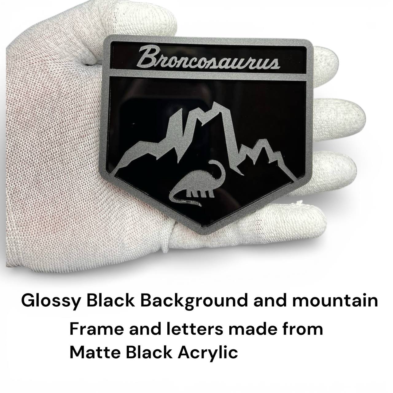 Laser-cut acrylic Broncosaurus badge designed for Ford Bronco off-road and adventure vehicles