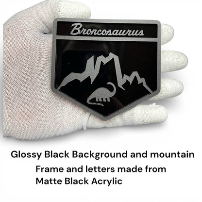 Laser-cut acrylic Broncosaurus badge designed for Ford Bronco off-road and adventure vehicles