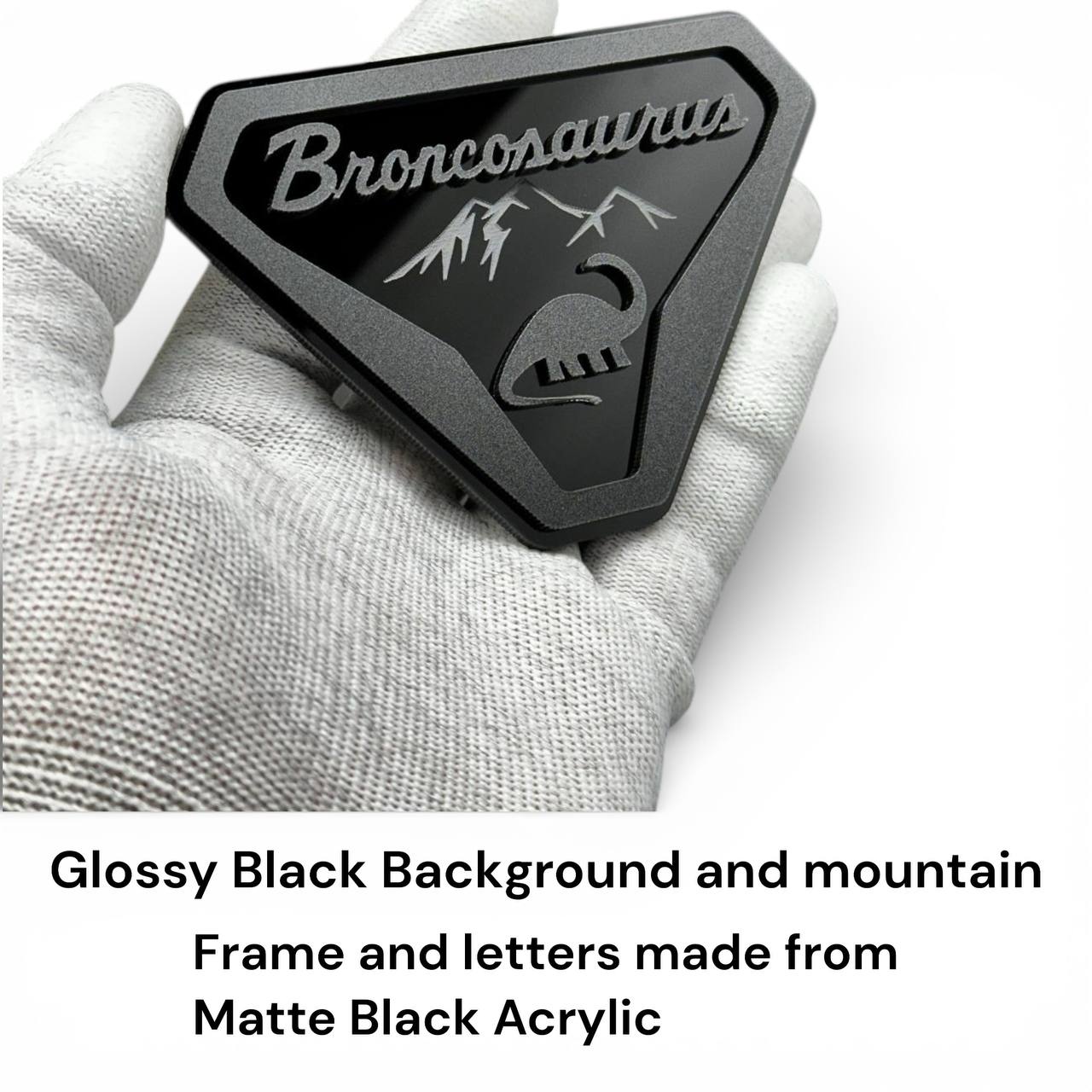 Custom Broncosaurus Ford Bronco badge shown in hand to display size and premium acrylic finish