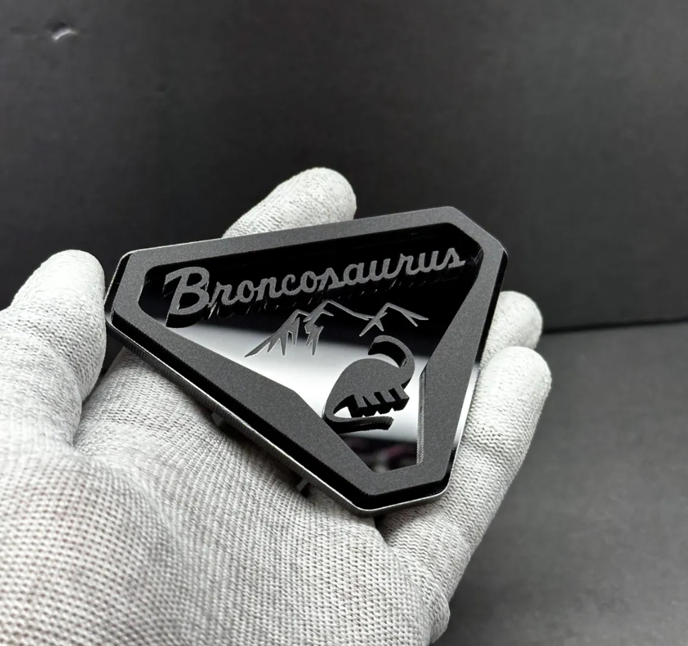 Custom Broncosaurus dinosaur badge for Ford Bronco SUV inspired by off-road and adventure lifestyle