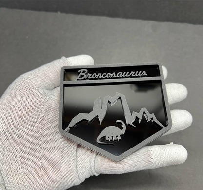 Custom Broncosaurus dinosaur badge for Ford Bronco SUV inspired by off-road and adventure lifestyle