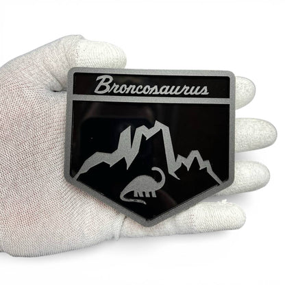Broncosaurus badge for Ford Bronco made from black and silver acrylic, custom dinosaur off-road emblem