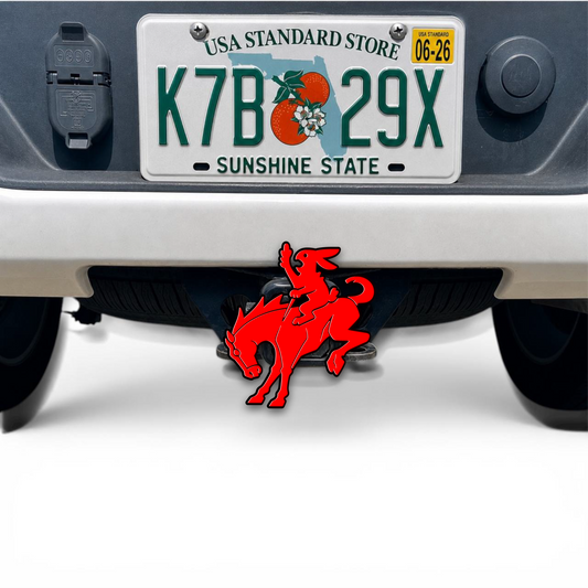Red and black 3D hitch cover featuring a cartoon bunny riding a horse, mounted on a vehicle tow hitch