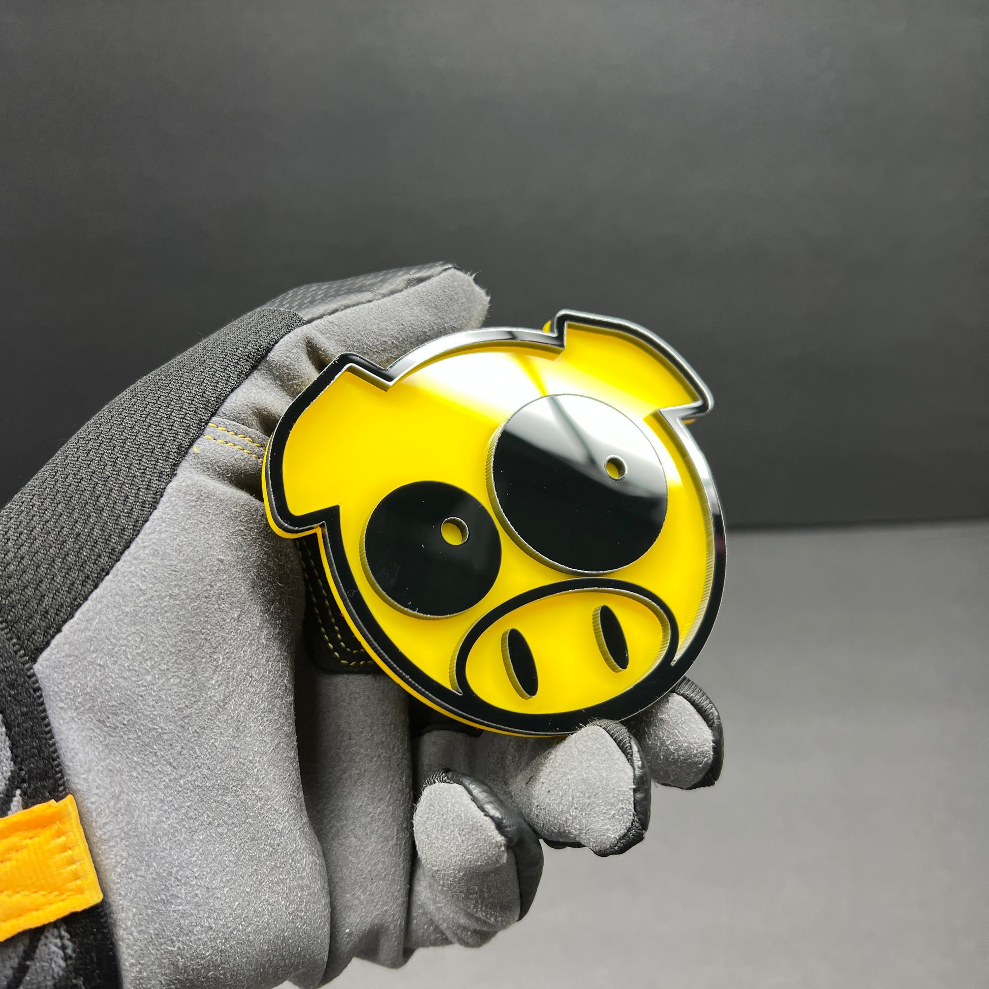 Funny pig exterior car badge made in a layered yellow and black design