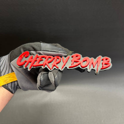 Cherry Bomb custom laser cut text badge with black gloss backing
