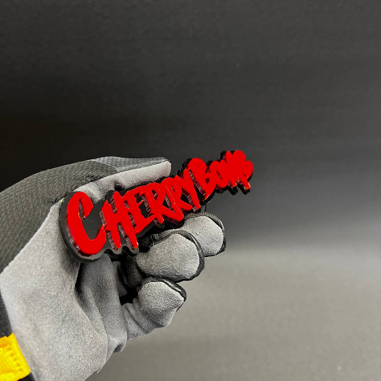 Cherry Bomb dripping font automotive emblem with glossy red finish