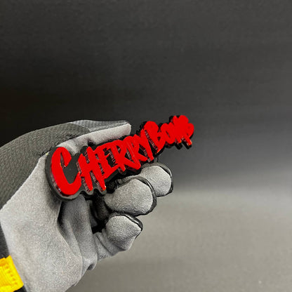 Cherry Bomb dripping font automotive emblem with glossy red finish