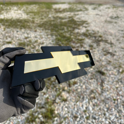 Chevy Bowtie automotive emblem in layered black and gold design